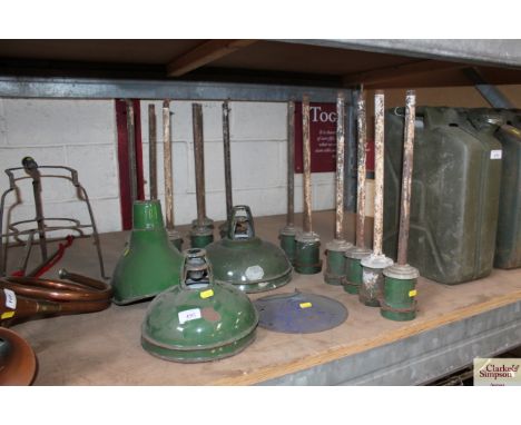 A collection of various vintage enamel light shades and holders