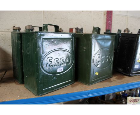 Three green Esso fuel cans and a CPO red painted fuel can