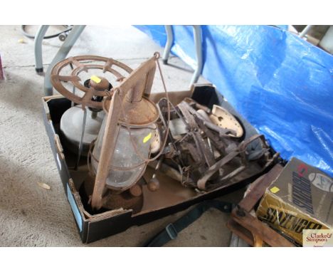 A box containing a Hurricane lamp, Primus stove, traps etc.
