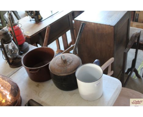 A large enamel mug, an enamel saucepan and another with iron lid