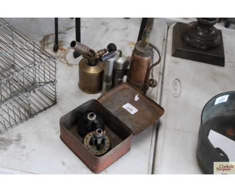 Two gas burners in a metal Primus tin, a paraffin blow lamp, a small blow lamp and a gas lighter