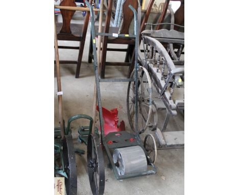 A vintage push hoe with ridger and plough attachments and front roller