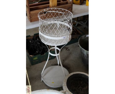 A wire work planter on metal two tier stand