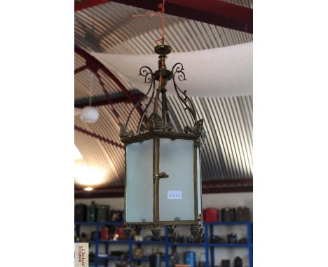 A brass octagonal hanging lamp with frosted glass shades