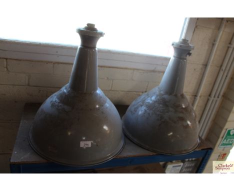 A pair of enamel industrial hanging lights