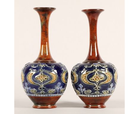 Pair of Doulton Lambeth Art Nouveau stone ware vases, of globe and shaft form, decorated with stylised flowers in green and y