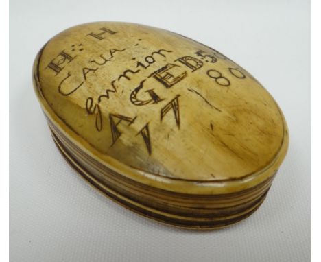 A HORN SNUFF BOX of oval form with sgraffito writing to the hinged lid as follows 'HH CAUA Gwnion AGED 50 1780', 3.5ins long 