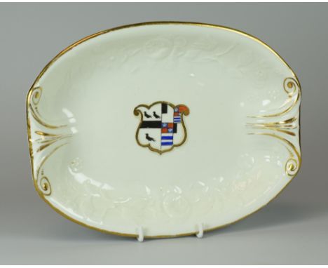 A SWANSEA PORCELAIN OVAL HERALDIC  DISH circa 1814-26 having a coat of arms for Lockwood impaling Manners-Sutton, within a mo