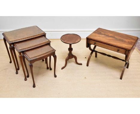 A 1950s walnut nest of three graduated coffee tables, a reproduction tripod table and a reproduction drop-leaf coffee table.