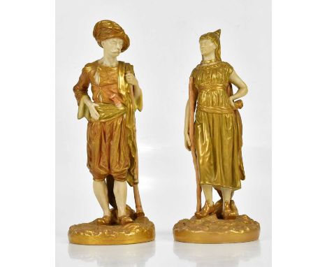ROYAL WORCESTER; a pair of gilded blush ivory figures, an Arab male and female, numbered 1243, height 22.5cm (2).