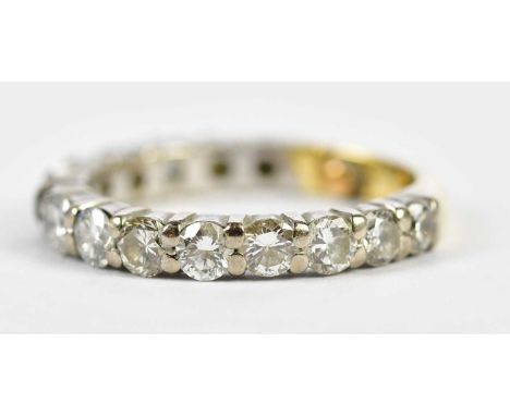 A yellow and white metal diamond three-quarter eternity ring set with fourteen round brilliant cut stones each weighing appro
