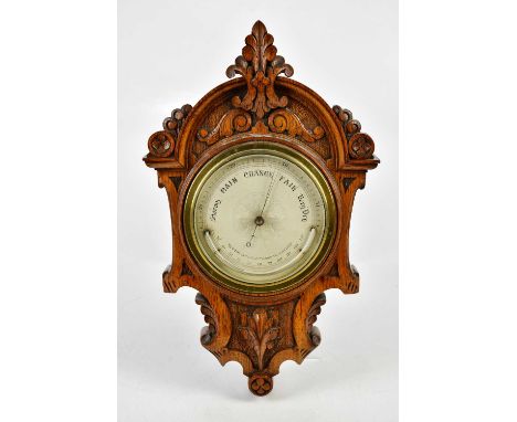 A late Victorian carved oak barometer, the silvered dial inscribed 'Newton &amp; Co, Fleet Street, Temple Bar, London', lengt