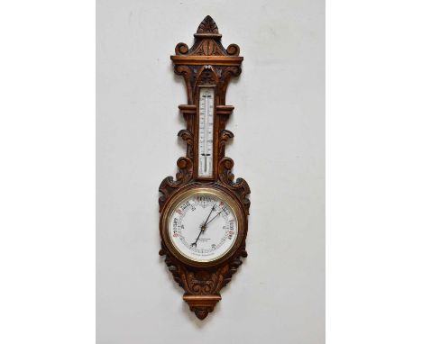 A late Victorian carved oak aneroid barometer, 88cm.Condition Report: Light general wear throughout otherwise appears in good