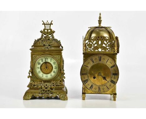 A reproduction brass lantern type mantel clock, with burnt finial above the silvered chapter ring, height 30cm and brass case