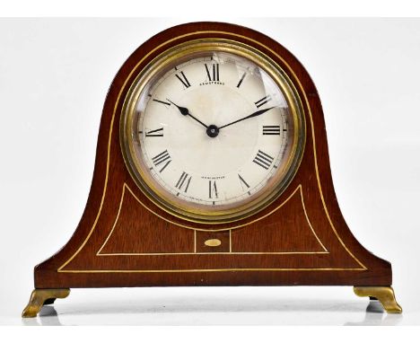 An early 20th century inlaid mahogany Napoleon hat shaped mantel clock, the engine turned dial set with Roman numerals, signe