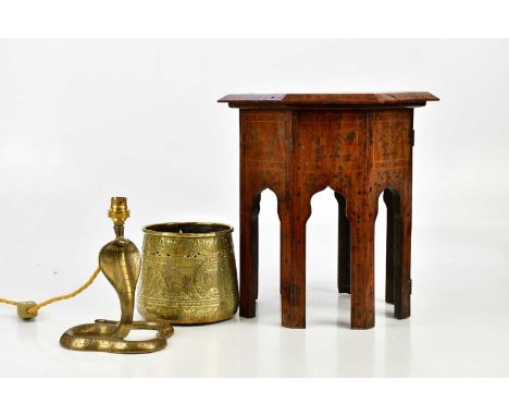 A mid 20th century octagonal topped Eastern brass inlaid occasional table, a brass serpent form table lamp and an Eastern bra