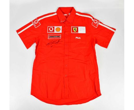 MICHAEL SCHUMACHER; a signed FILA Ferrari shirt, signed to the front, size XL.Condition Report: Creasing and light general we