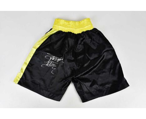 SYLVESTER STALLONE (ROCKY BALBOA); a pair of signed black and yellow boxing shorts.Condition Report: Creasing and light gener