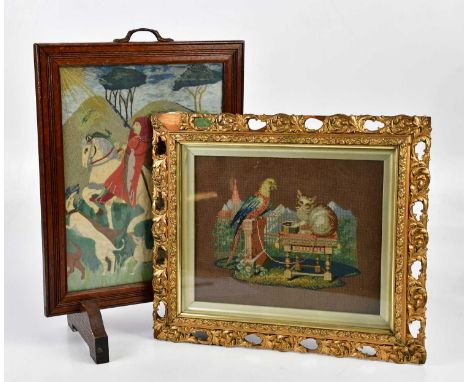 An oak needlework firescreen, height 53cm, together with a needlework of a cat and parrot in ornate gilt frame (2).