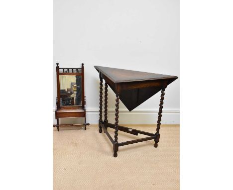 A 1920s oak drop-leaf corner table on barley twist supports, width 85cm, height 77cm, and an oak wall hanging toilet mirror w