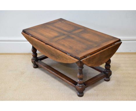 A reproduction oak drop-leaf coffee table, length 120cm, height 50cm. 