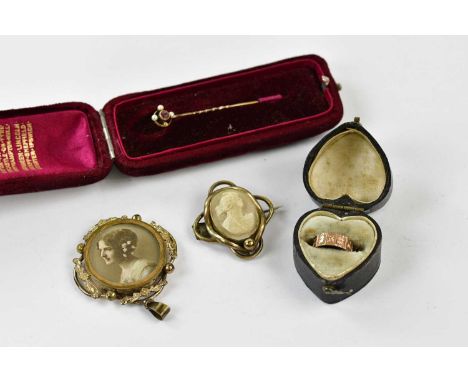 A Victorian yellow metal child's ring with embossed floral detail, size approx B, unmarked, a stick pin set with seed pearls,