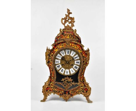 A reproduction Boulle work effect mantel clock in the Rococo style, the dial set with Roman numerals, height 58cm.