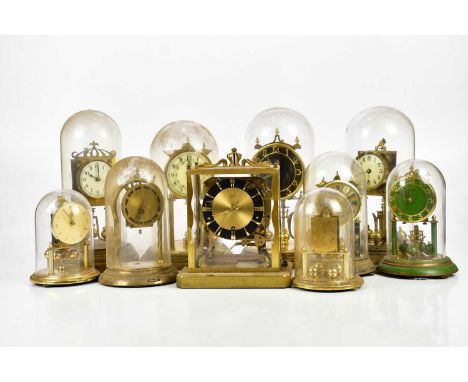 A collection of nine anniversary clocks, under perspex domes, with a Schatz mantel clock with movement striking on eight gong