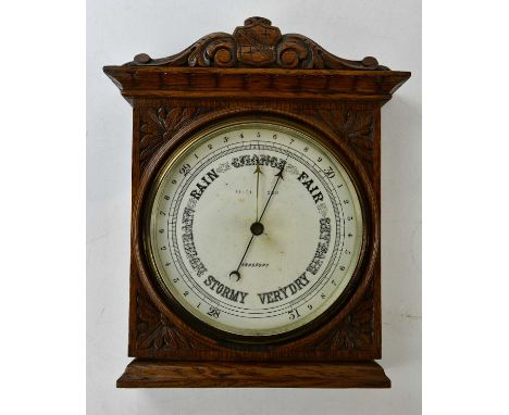 An early 20th century carved oak aneroid barometer, dial signed 'Bradford', 37 x 30cm.