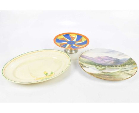 CLARICE CLIFF; a cake stand and platter, together with a hand painted wall charger, largest 30cm.