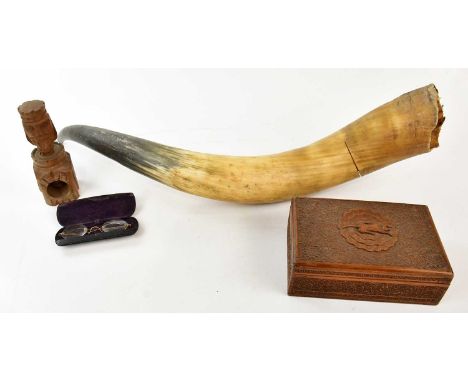 A large cow horn, a pair of spectacles, a modern carved box and a nut cracker.