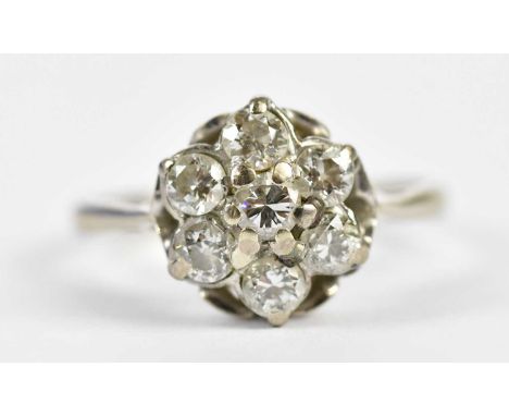 An 18ct white gold seven stone diamond flowerhead ring, each stone weighing approx. 0.20cts, size K, approx. 3g.Condition Rep
