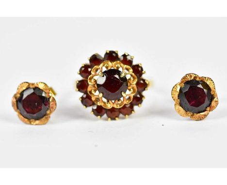 An 18ct yellow gold garnet set dress ring, size K, approx 4g, and a pair of yellow metal garnet set earrings.