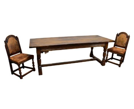 A reproduction oak refectory dining table on block legs, length 225cm, width 93cm, and six oak framed leather back and seated