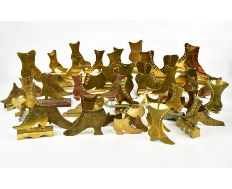 A large collection of brass mantel shelf boots, approx twenty-six pairs.