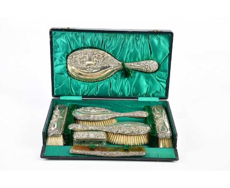 JOSEPH GLOSTER; an Edward VII hallmarked silver five piece dressing table set embossed with scrolling decoration, Birmingham 