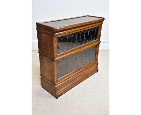GLOBE WERNICKE; an oak two tier metal bound stacking bookcase with leaded glazed up and over door, width 87cm, depth 33cm, he