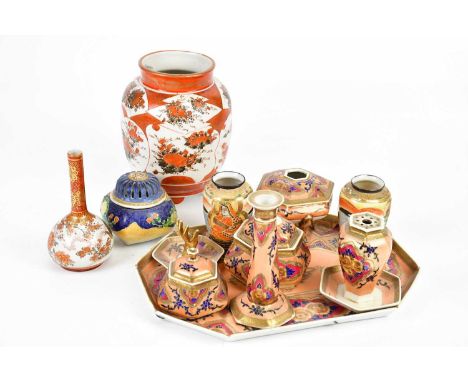 An early 20th century Japanese Kutani vase painted with floral detail on three feet, height 20cm, a similar pair of bud vases