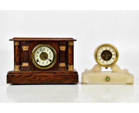 An early 20th century French alabaster drum mantel clock, the dial set with Roman numerals, height 23cm and an oak cased mant
