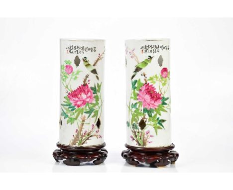 A pair of Chinese Famille Rose sleeve vases painted with exotic birds and floral sprays on associated wooden stands, height 3