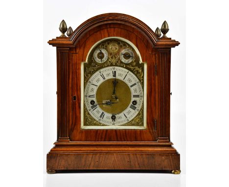 An Edwardian walnut eight day chiming mantel clock, the matted brass dial with silvered Roman numeral chapter ring beneath su