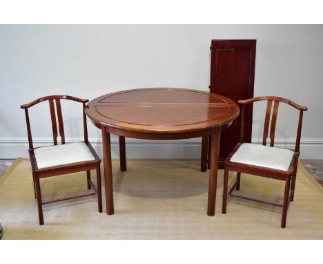 A Chinese rosewood dining table with three additional leaves, on column supports, and eight chairs.