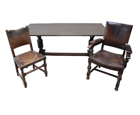 A late 19th century oak refectory table, together with six oak framed dining chairs with leather seats and backs, table lengt