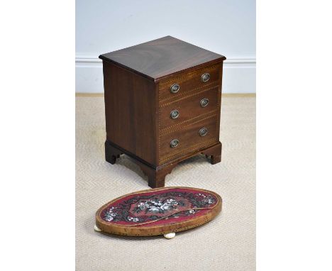 A reproduction inlaid commode in the form of a three drawer chest on bracket feet and a Victorian walnut and beadwork stand (