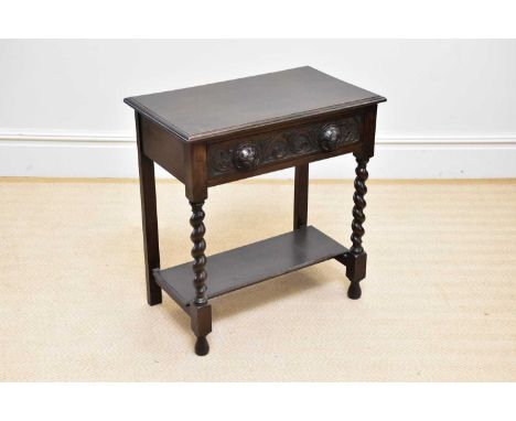 An early 20th century oak side table with single frieze drawer above undertier, on barley twist supports, width 67cm, depth 4