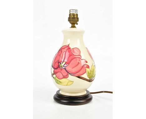 MOORCROFT; a baluster shaped table lamp in the 'Magnolia' pattern, on plinth, height including fitting 28cm.