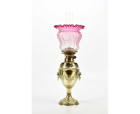 A Victorian silver plated oil lamp with clear glass chimney and cranberry shade, height 60cm.Condition Report: Minor nibbles 