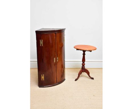 A Georgian mahogany bowfront hanging corner cupboard with H-hinges, height 108cm, and a Victorian tilt-top tripod table (2).