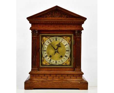 Winterhalder &amp; Hofmeier; a late 19th century carved oak mantel clock of architectural form, the brass face with applied s