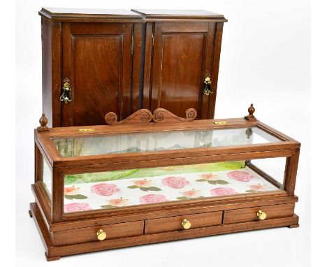 A modern tabletop jewellery cabinet with hinged top and three base drawers, length 61cm, depth 24cm, height 24cm, and two cup